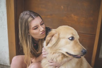 Woman Hugging Tan Dog