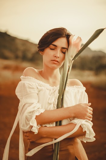 Woman Hugs White Flower Stem