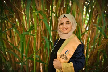 Woman in a Beige Scarf at a Bamboo Field