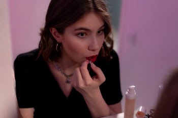 Woman in a Black Top Putting on Red Lipstick on Her Lips · Free Stock Photo