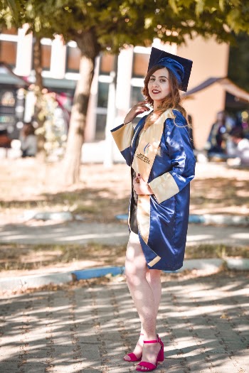 Woman In A Blue And Yellow Graduation Toga