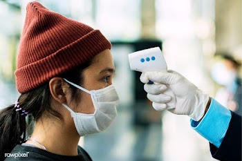 Woman in a medical mask getting her temperature measured by an electro.. | Free  photo - 2293380