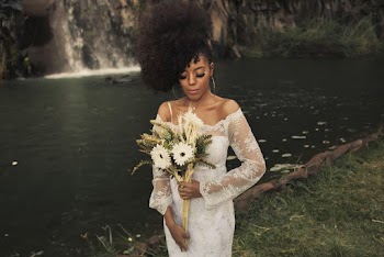 Woman in a White Dress Holding Flowers