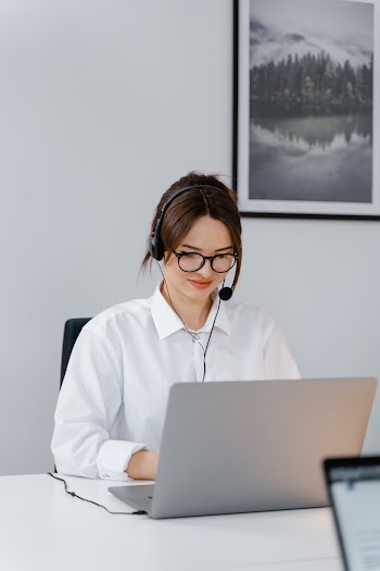 Woman in a White Dress Shirt Working on Her Laptop · Free Stock Photo