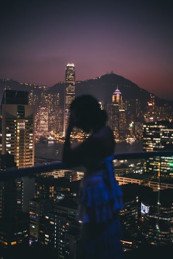 woman in backless top standing on veranda