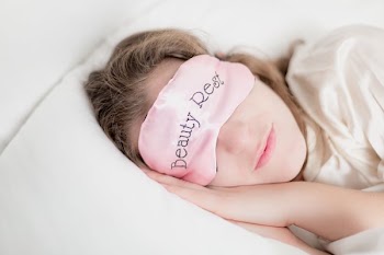 Woman In Beauty Rest Mask In Pillow