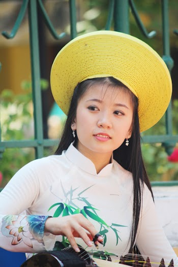 Woman in Beige, Green, and Pink Floral Long-sleeved Top With Yellow Hat