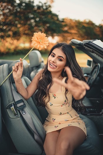 Woman in Beige Spaghetti Strap Mini Dress Riding on Convertible Car