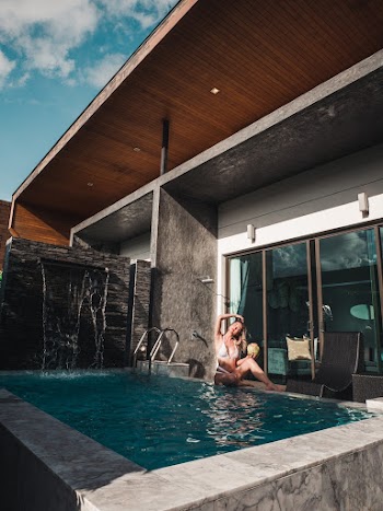 Woman in Bikini Sitting Poolside
