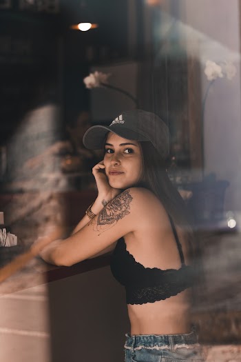 Woman in Black Adidas Cap and Lace Brassiere