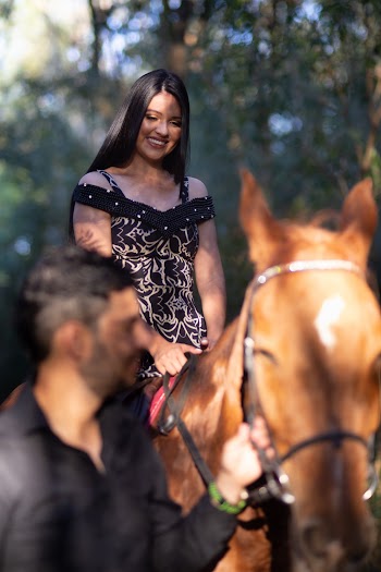 Woman in  Black and Gray Halter Dress Horse Back Riding
