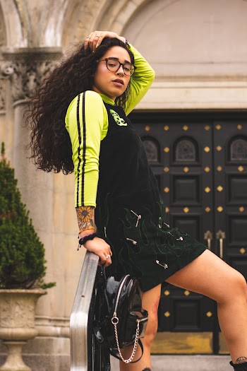 Woman in Black and Green Long-sleeved Shirt Posing
