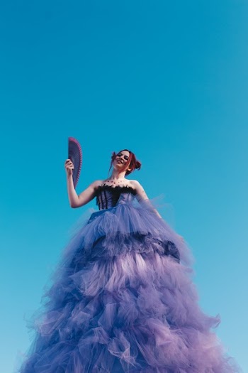 Woman in Black and Purple Ruffle Dress Holding Hand Fan