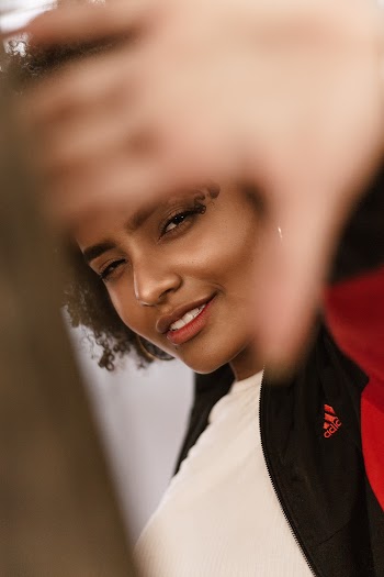 Woman in Black and Red Adidas Jacket