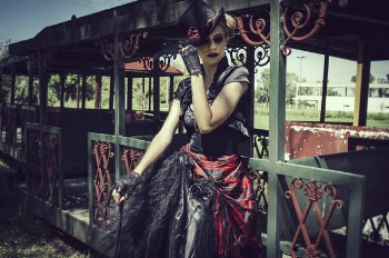 Woman in Black and Red Short-sleeved Dress Standing in Front of Green Steel Structure