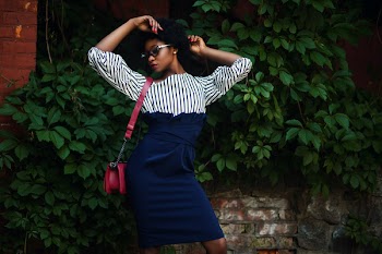 Woman in Black and White Striped Long-sleeved Dress Wearing Red Leather Sling Bag