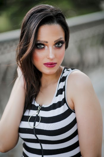 Woman in Black and White Striped Top