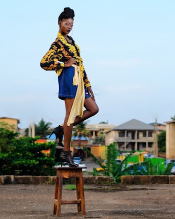 Woman in Black and Yellow Top and Blue Skirt Standing on Brown Wooden Stool