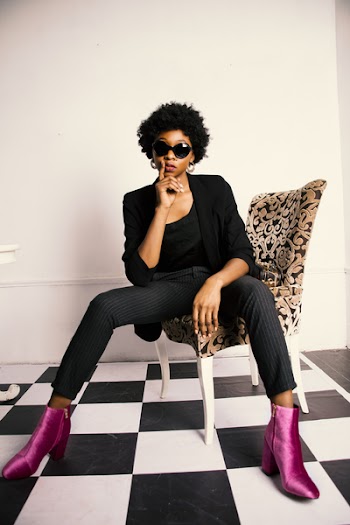 Woman in Black Blazer and Dress Pants Sitting on Chair