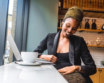 Woman in Black Blazer with a big smile on her face