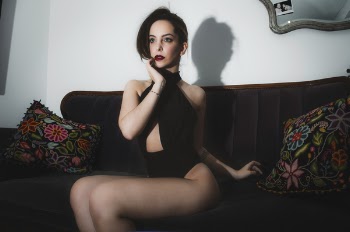 Woman in Black Body Suit Sitting