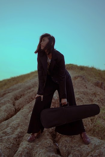 Woman In Black Carrying A Violin