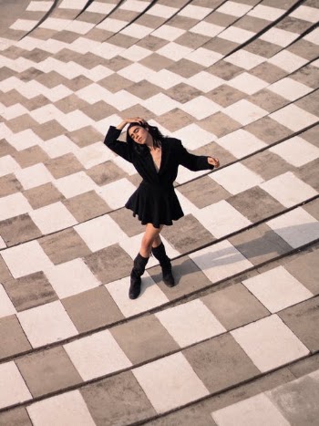 Woman in Black Coat and Black Pants Standing on White and Brown Floor Tiles · Free Stock Photo