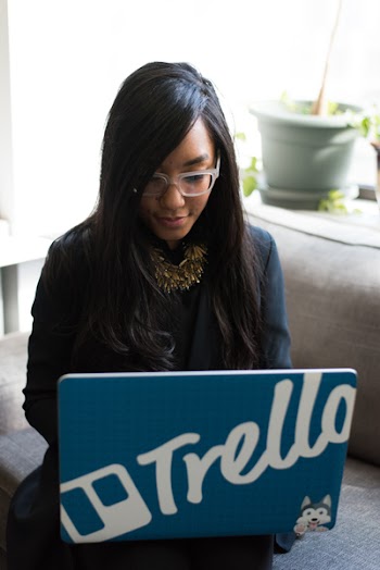 Woman in Black Coat Holding Her Blue Laptop Computer