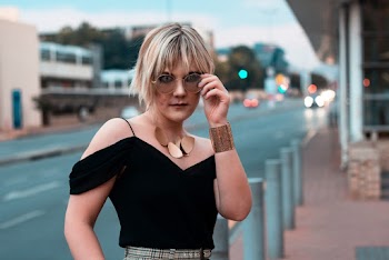 Woman In Black Cold Shoulder Top Wearing Brown Sunglasses