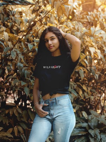 Woman In Black Crew Neck T-shirt And Blue Denim Jeans