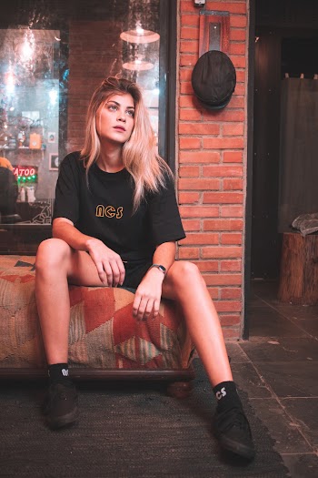 Woman in Black Crew Neck T-shirt Sitting On Chair