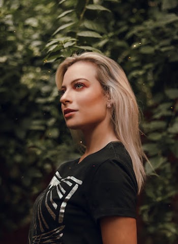 Woman in Black Crew-neck T-shirt Standing Near Green Tree