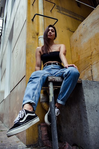 Woman IN Black Crop Top And Blue Denim Jeans
