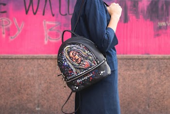 Woman in Black Dress and Leather Backpack