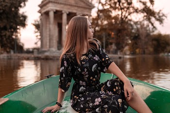 Woman in Black Dress Riding Boat