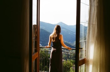 Woman in Black Dress Standing on Window · Free Stock Photo