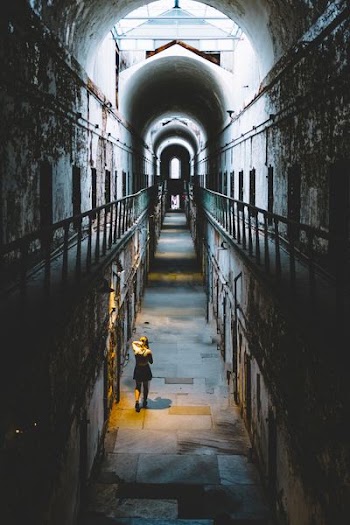 woman in black dress walking inside room