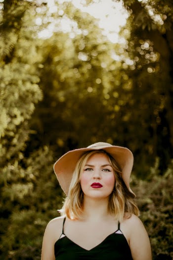 Woman in Black Dress Wearing Sunhat during Daytime