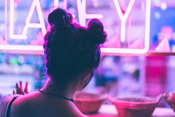Woman in Black Hair Looking at the Window