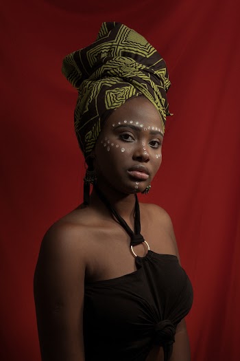 Woman In Black Halter Top and Green Headwear