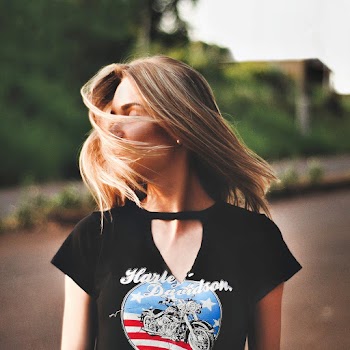 Woman In Black Harley Davidson Shirt With Hair On Her Face
