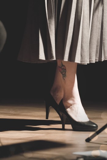 Woman in Black Heeled Shoes Standing on Brown Surface