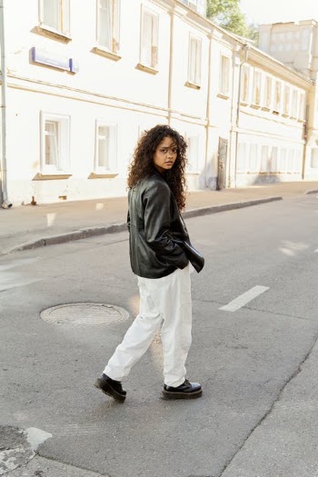 Woman in Black Jacket and White Pants Standing on Road · Free Stock Photo