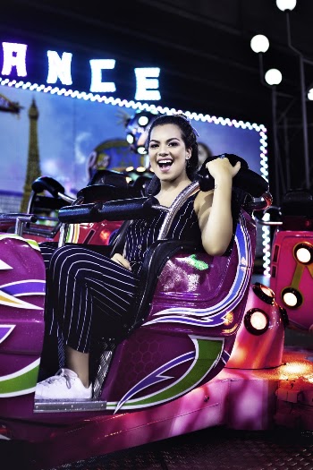Woman in Black Jumper Riding on Purple Component