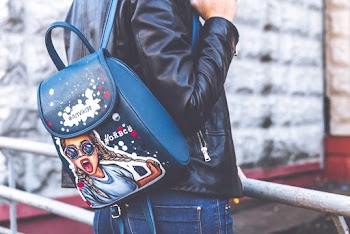 Woman in Black Leather Jacket, Blue Denim Bottoms and Black Leather Backpack