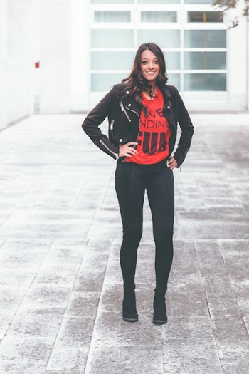 Woman In Black Leather Jacket Standing On Concrete Ground