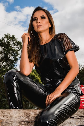 Woman in Black Leather Pants Sitting on Log