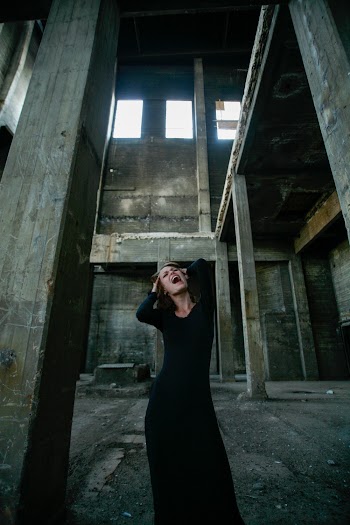 Woman In Black Long Sleeve Dress Screaming 