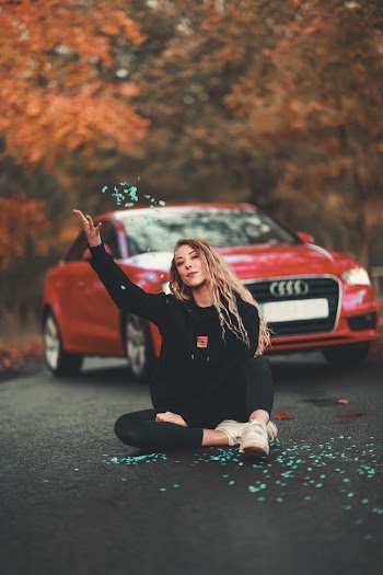 Woman in Black Long Sleeve Shirt Sitting on Road