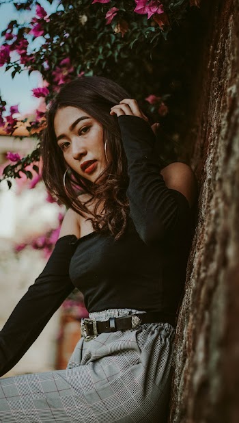 Woman in Black Long Sleeve Shirt Standing Beside A Tree